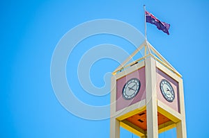 Close-up Square Clock tower at the Rocks, shopping mall with Australia Flag Sydney, Australia.