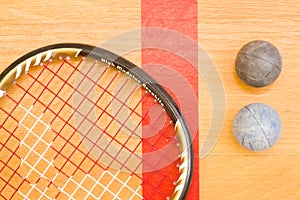 Close up of a squash racket and ball on the wooden background, sport concept