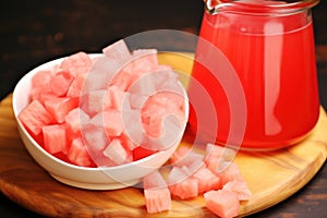 close up of squeezed watermelon rind beside filled juice jug