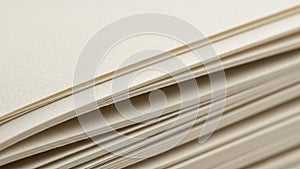 Close up of a stack of beige paper sheets with a textured surface