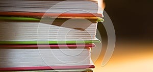 Close-up of a stack of books. The concept of home reading of paper books, school education and Institute, back to school.