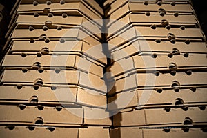 Close-up of a stack of brown pizza delivery boxes