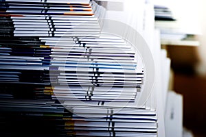 Close-up of stack of documents on office desk in library Selective focus