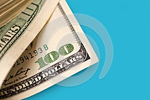 Close Up of Stack of dollars on blue background