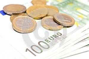 Close-up Stack of Euro banknotes and coins. 100 Euro banknotes.