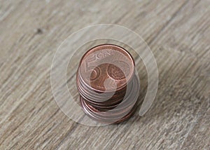 Stack of five euro cent coins on wooden background