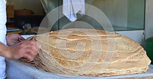 a stack of arabic bread called Markook in lebanon, juste after being cooked on a convex iron plate.
