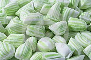 Close up of stack of green and white striped mint candy