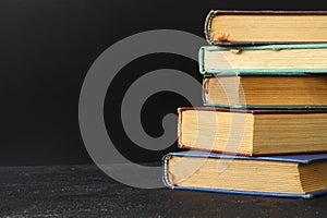 Close-up of stack of old used books background. Pile of vintage old hardback books. Back to school. Copy space