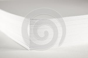 Close up of stack of papers on white background. Office: Pile of Paper