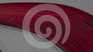 Close-up of a stack of red quilling stripes of paper. Macro