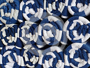 Close up stack of rolled blue and white towels