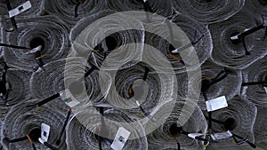 Close up of stack of rolls at the industrial plant. Creative. Insulation rolls with cables.