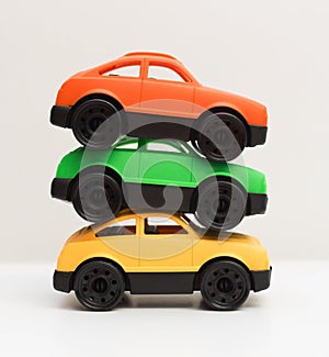 Close up stack of three colorful toy cars made from recyclable non toxic safe plastic