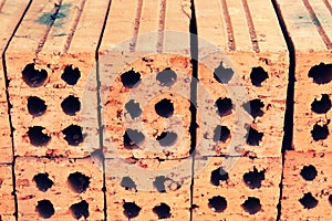 Close up of stacked clay bricks - constructional material - industrial production of bricks