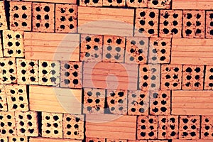 Close up of stacked clay bricks - constructional material - industrial production of bricks