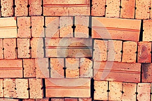 Close up of stacked clay bricks - constructional material - industrial production of bricks