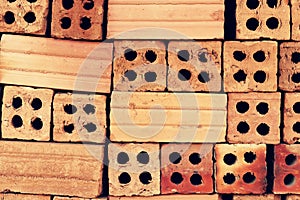 Close up of stacked clay bricks - constructional material - industrial production of bricks