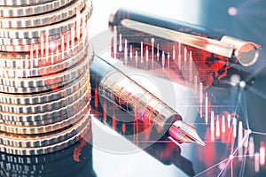 Close up of stacked coins and fountain pen on desktop with glowing falling red forex chart on blurry backdrop. Stock exchange and