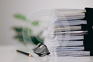 Close-up stacking of office working document with paper clip folder on white table