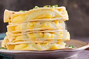 Close-up of Stacks of Kystyby - thin tortillas filled with mashed potatoes and onions on a plate