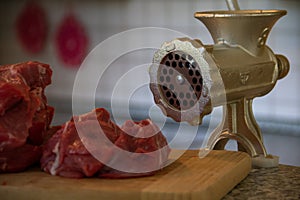 Close up Stainless steel Meat grinder with kitchen Background. Modern Kitchen Interieur Concept. Traditional manual meat grinder photo