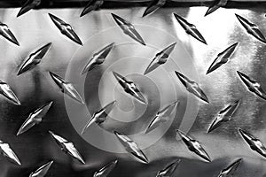 Close up of stainless steel sheet with diamond plate pattern, metallic background