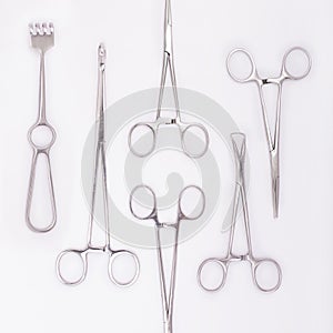 Close-up of steel surgical instruments on white background