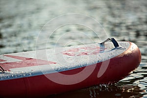 Close up of a stand up paddle board SUP and paddle on a dock