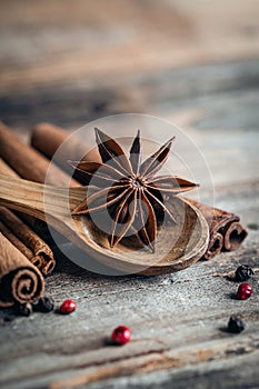 Close-up, star anise and cinnamon sticks on a wooden background, macro shot.