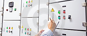 Close up starter button air handling unit AHU control panel has Technician checking heat