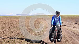 Close up static front view male caucasian cyclist riding bicycle smile pass pov on tranquil countryside road in caucasus mountains