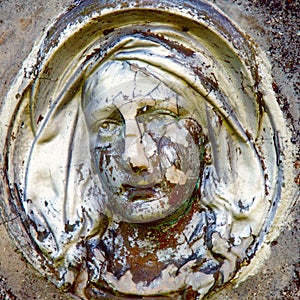 Close up of statue Virgin Mary. Vintage sculpture of sad woman i