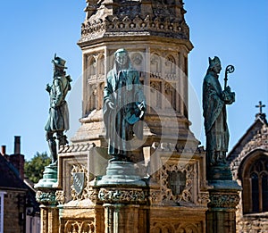 Close up of statues of Sir Francis Drake, Abbot Bradford and Bishop Roger on the Digby Memorial Cross in front of Sherborne Abbey