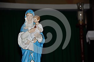 Close-up of statuette with image of Our Lady holding the boy Jesus.