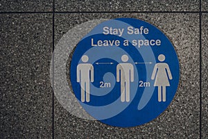 Close up of stay safe leave a space 2 metres  social distancing sign in London, UK