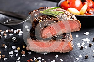 Close-up of steak Top Blade roasting medium ready to eat on dark stone background