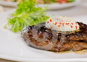 Close Up of Steak Topped with Herbed Butter