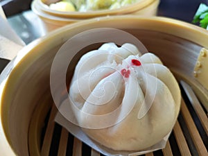 Close-up steam chinese pork bun in wooden container sold in Thailand