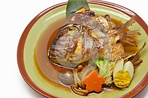 Close-up steamed salmon Head with soy sauce in green plate Japan