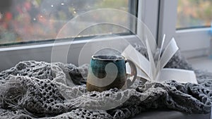 Close up. Steaming coffee cup on a rainy day window background. cozy atmosphere, in cold weather. Rainy Day Mood.