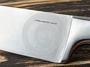 Close-up of steel marking on a professional chef knife blade. Modern kitchen utensils made of high carbon molybdenum vanadium