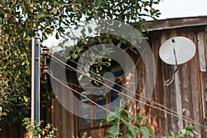 Close-up steel poles, an Electrical insulator, and old wires outside the house, the minimalist design