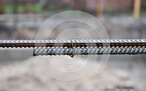 A close-up of steel reinforcement bars, iron bars with binding wires to reinforce the house construction