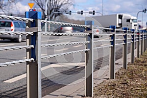 Close-up of steel ropes. Cable barrier, also called guard cable or wire road safety barrier, is increasingly used road safety