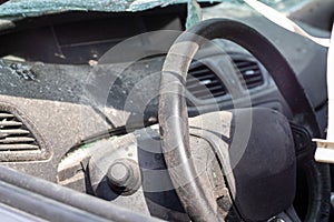 Close-up of the steering wheel of a car after an accident. The driver\'s airbags did not deploy. Soft focus.