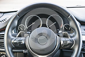 Close up of steering wheel. Car dashboard. Navigation screen. Modern car interior details