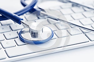 Close up of a Stethoscope on computer keyboard on white desk
