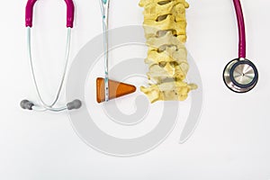 Close up stethoscope ,knee jerk and spine model on white background