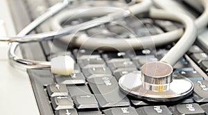 Close-up of stethoscope on laptop keyboard